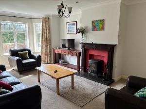 a living room with a couch and a fireplace at 19 Westlands in Westport