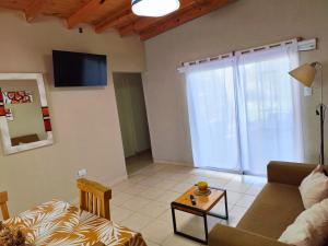 a living room with a couch and a table at Casa Nuup in Río Tercero