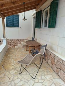 a patio with chairs and a table on a building at Apartments Elvira in Sveta Nedelja
