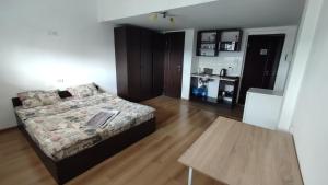 a bedroom with a bed and a table in it at Мансарда біля АС2 in Ivano-Frankivsk