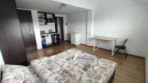 a living room with a bed and a table at Мансарда біля АС2 in Ivano-Frankivsk
