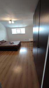 a large room with a bed and a wooden floor at Мансарда біля АС2 in Ivano-Frankivsk