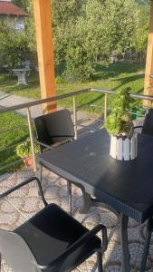 a black table and chairs on a patio at Guesthouse Oasis in Baks-Rrjoll