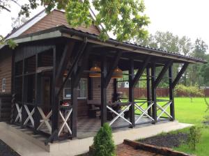 a large wooden pavilion with a deck in a yard at New House in Petergof