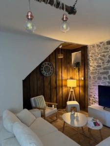 a living room with a white couch and a table at L'escapade du temps in Les Épesses