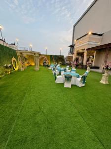 a group of chairs and tables on a lawn at Fun Square Hotel in Sangrūr