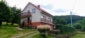 a house on a hill with at Noclegi Renata in Solina