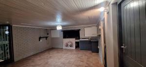 an empty room with a kitchen and a hallway at HL Self-catering Accommodation in Bonnievale +10 photos