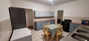 a kitchen with a table and chairs in it at HL Self-catering Accommodation in Bonnievale