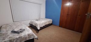 a room with two beds and a dresser in it at HL Self-catering Accommodation in Bonnievale