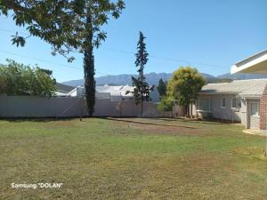 a yard with a fence and a house at HL Self-catering Accommodation in Bonnievale