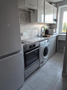 a kitchen with a washer and dryer in it at Melnragė in Melnragė