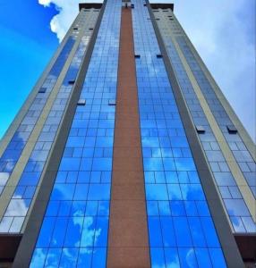 a tall building with a blue sky in the background at GUARULHOS FLAT CENTER - Apart-Hotel in Guarulhos
