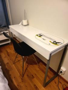 a white table with a surfboard on top of it at Comfort Us 2 - Cozy Private Home in Uppsala