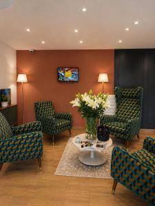 a living room with couches and a table and flowers at La Frégate in Collioure