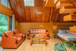 a bedroom with leather furniture and a bed at The Social Stays Kasol in Kasol +106 photos