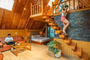 a woman is climbing a staircase in a house at The Social Stays Kasol in Kasol