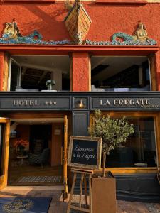 a hotel with a sign in front of a building at La Frégate in Collioure