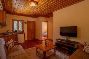 a living room with a couch and a flat screen tv at Odile Hotel by Naturelife in Cıralı