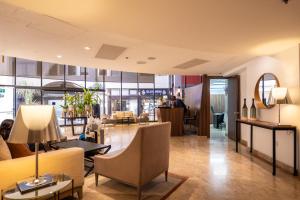 a lobby of a hotel with chairs and tables at Superb Beachfront Apartments with Shelter by Sea N' Rent in Tel Aviv