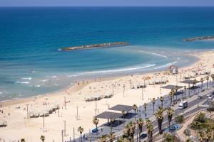 an aerial view of a beach with people and the ocean at Superb Beachfront Apartments with Shelter by Sea N' Rent in Tel Aviv