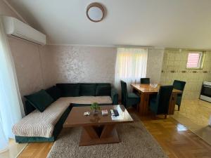 a living room with a couch and a table at Blue Escape in Danilovgrad