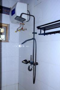 a shower with a laptop on the wall of a bathroom at Tenzi BnB in Jinja +23 photos