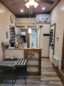 a kitchen with a counter and a table in a room at The Tiny House at Deer Holler in Sugar Tree