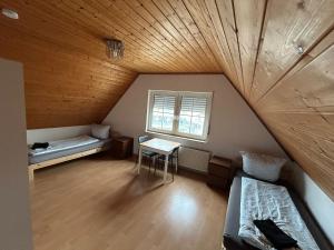 an attic room with a bed and a table at ME Apartments - Big Space in Bad Camberg