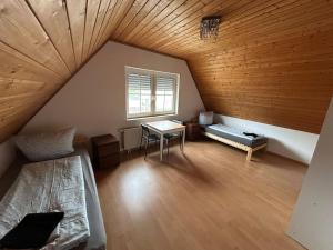 a attic room with a bed and a table at ME Apartments - Big Space in Bad Camberg +5 photos