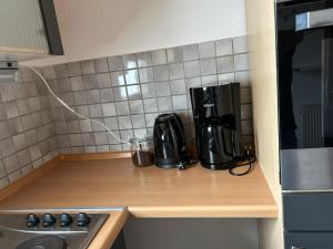 a kitchen counter with a coffee maker on a counter top at ME Apartments - Big Space in Bad Camberg