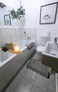 a bathroom with a tub and a toilet and a sink at Crabb Cottage and escape in St Lucia +43 photos