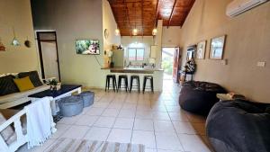 a living room with a couch and a kitchen at Crabb Cottage and escape in St Lucia