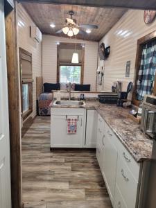 a kitchen with a sink and a counter top at The Tiny House at Deer Holler in Sugar Tree