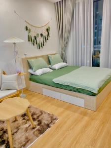 a bedroom with a large bed and a table at Green Chill Studio in An Khê +14 photos