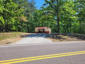 a small building on the side of a road at The Tiny House at Deer Holler in Sugar Tree
