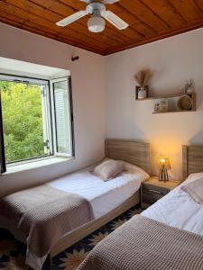 a bedroom with two beds and a window at Anezo's Exceptional View in Spetses