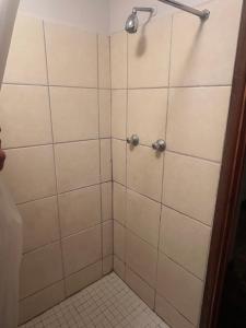 a bathroom with a shower with white tile at 13 bedford street in Grahamstown +16 photos