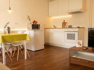 a small kitchen with a table and a microwave at Apartment Bruneck Central in Brunico