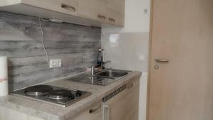 a kitchen with a sink and a counter top at Zum Hopfenbauer in Rudelzhausen