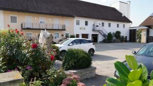 a white car parked in front of a building at Zum Hopfenbauer in Rudelzhausen