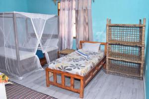 a bedroom with a bed with a canopy and a bed istg at Bamboo Garden B&B in Kendwa