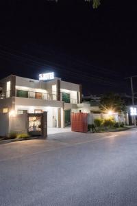 a building with a sign on it at night at Hotel Multan Avenue Multan in Multan