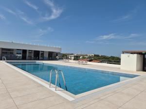 a swimming pool on the roof of a building at Libra Aparthotel in Bibione