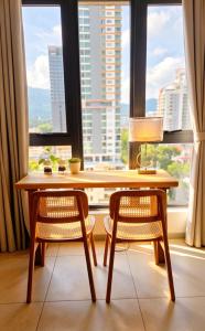 a table and two chairs in front of a window at Central Georgetown Studio with Nespresso Machine in George Town