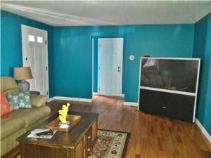 a living room with a couch and a flat screen tv at Summer Sea Vacation Rental in South Yarmouth