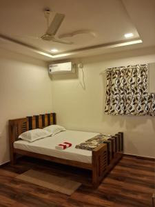 a bedroom with a bed and a ceiling fan at Love Villa in Kottiyam