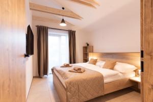 a bedroom with a bed with towels on it at Vinařství Herůfek in Zaječí