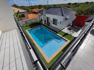 a swimming pool on the roof of a house at Casa-Pel Guest Wing in Palatswe
