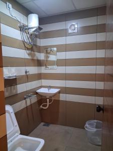 a bathroom with a sink and a toilet at Love Villa in Kottiyam +23 photos